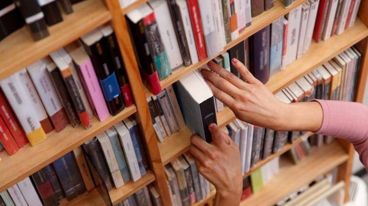 Woman in a library selecting a book