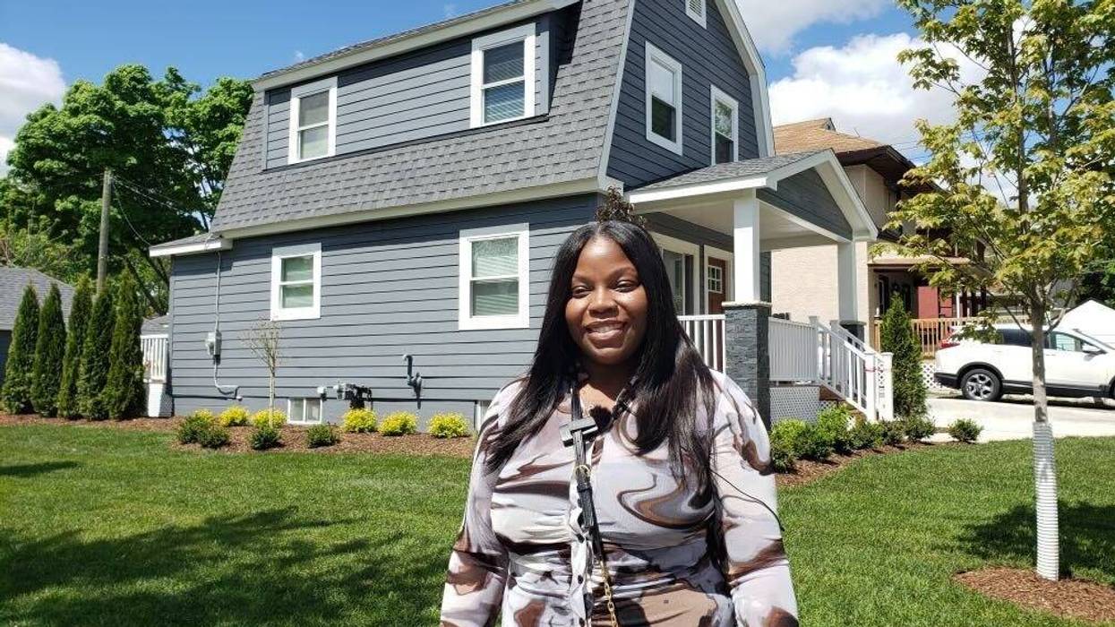 Woman in front of house