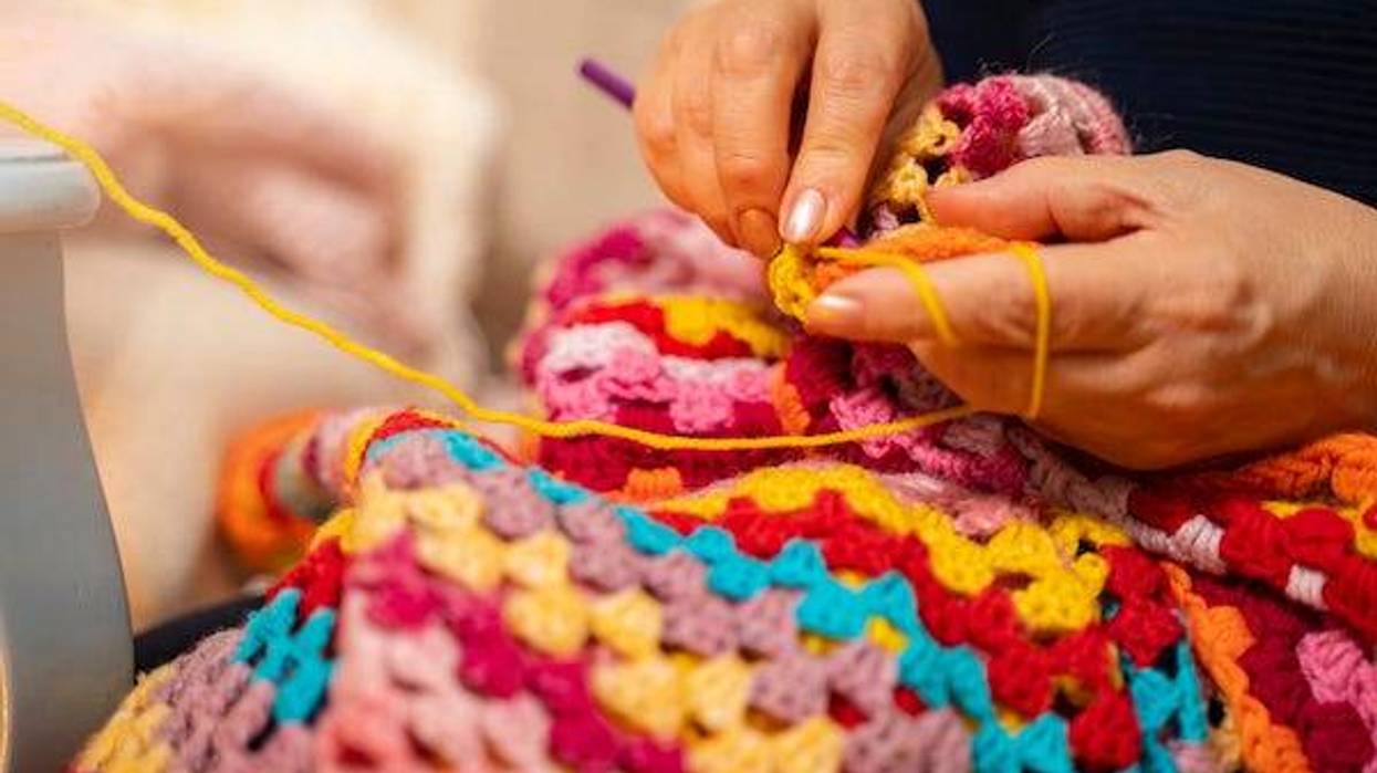 Woman knitting blanket