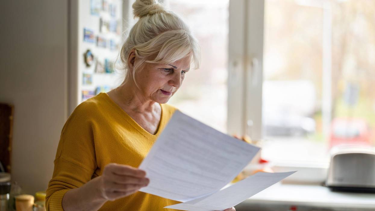 woman looking at forms in her hand