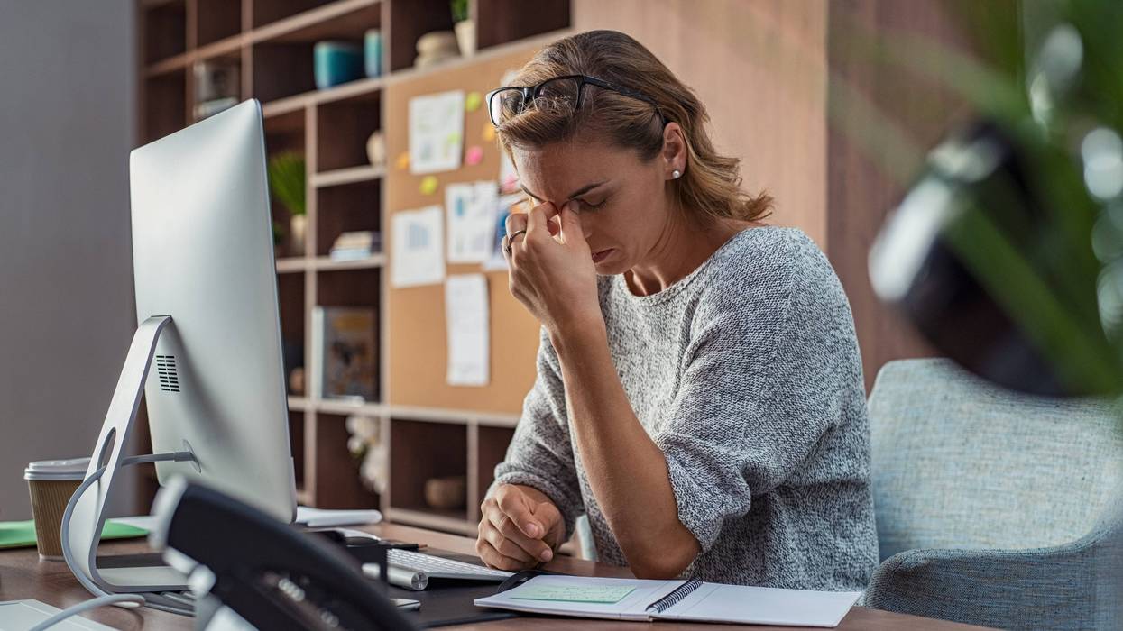 woman looking stressed at work