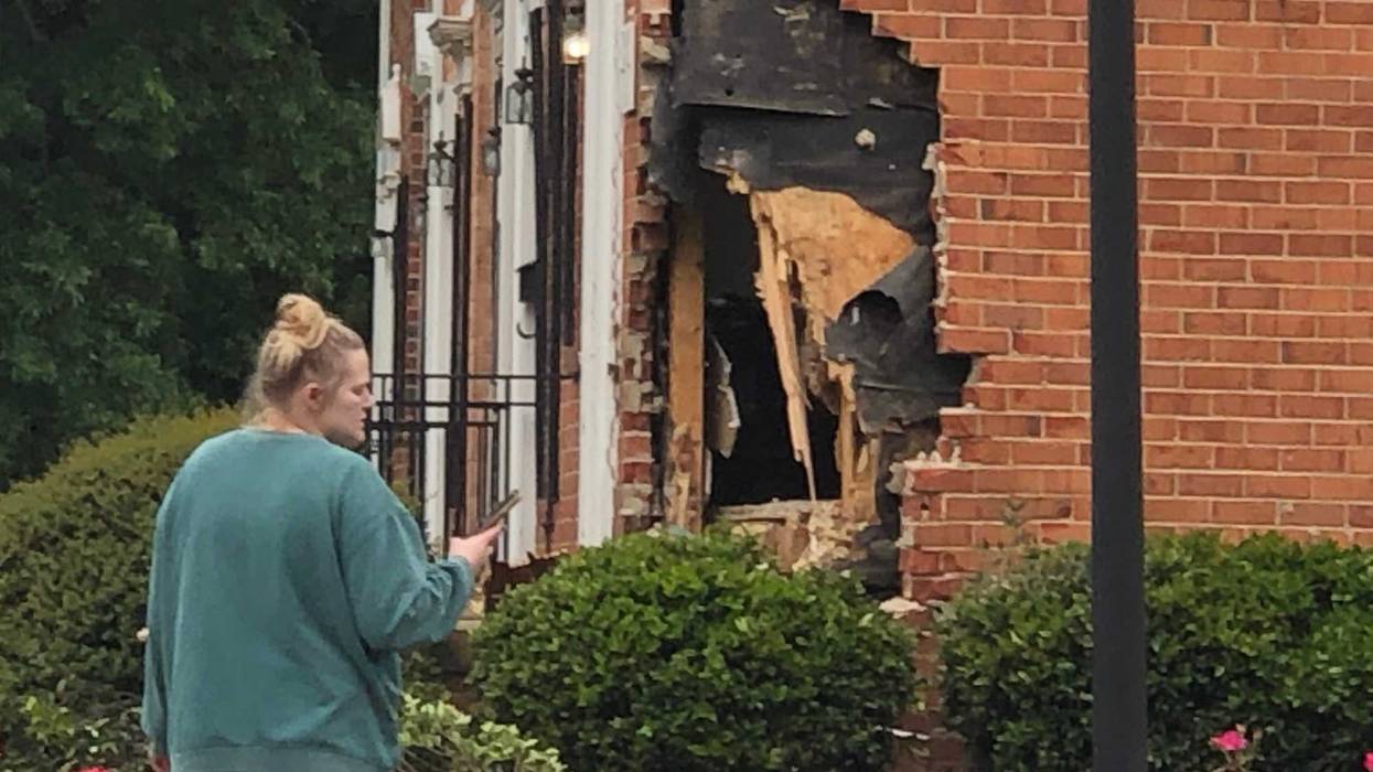 Woman looks at damaged apartment along Bremner Boulevard.