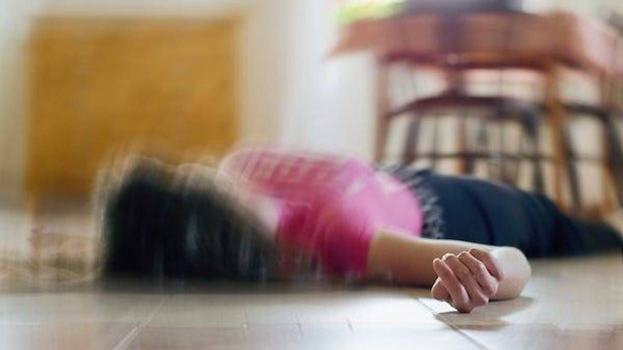 Woman lying on the floor after suffering a stroke
