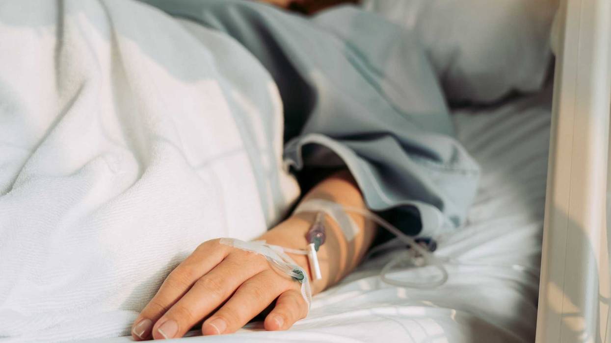 Woman lying sick in hospital.