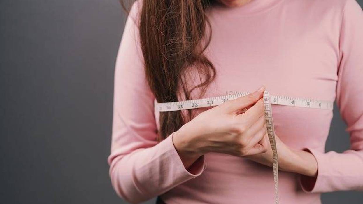 Woman measuring her breasts