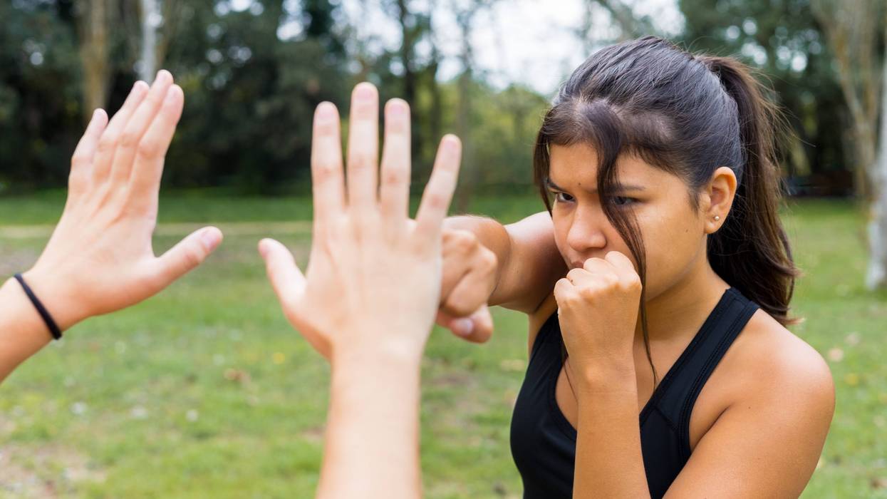 woman practicing martial arts self-defense outdoors