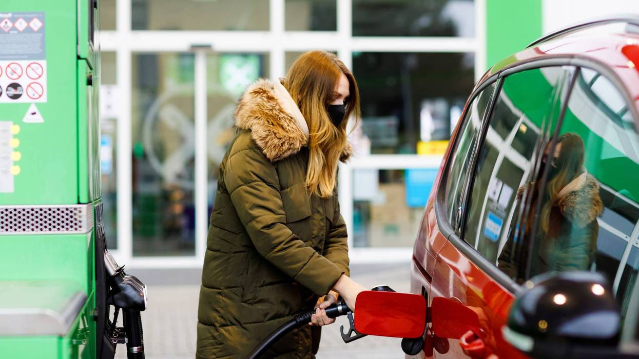 Woman pumping gas
