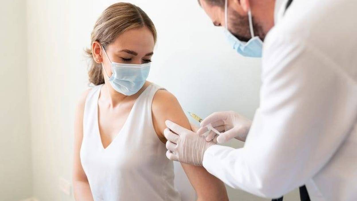 Woman receiving shot from doctor