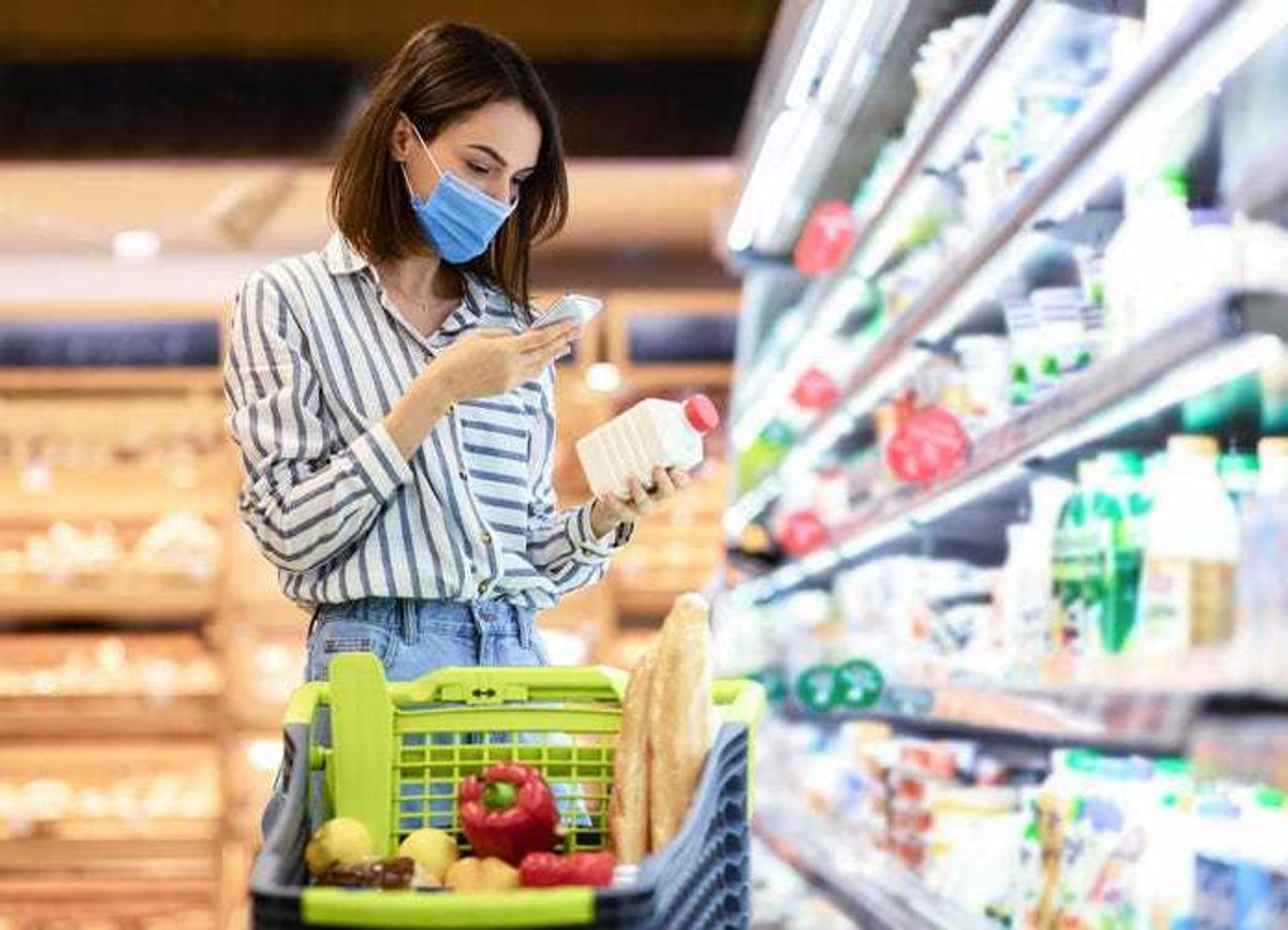 Woman shopping for milk.