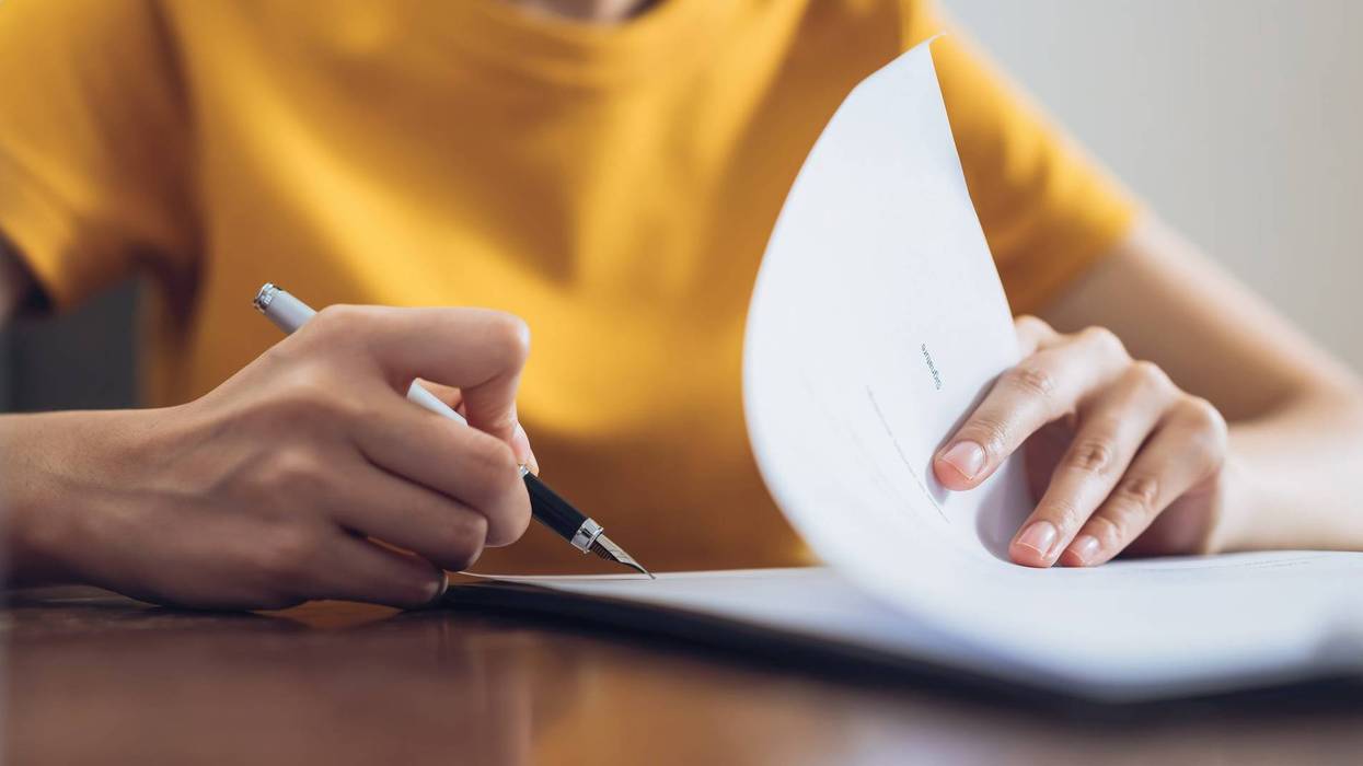 Woman signing document