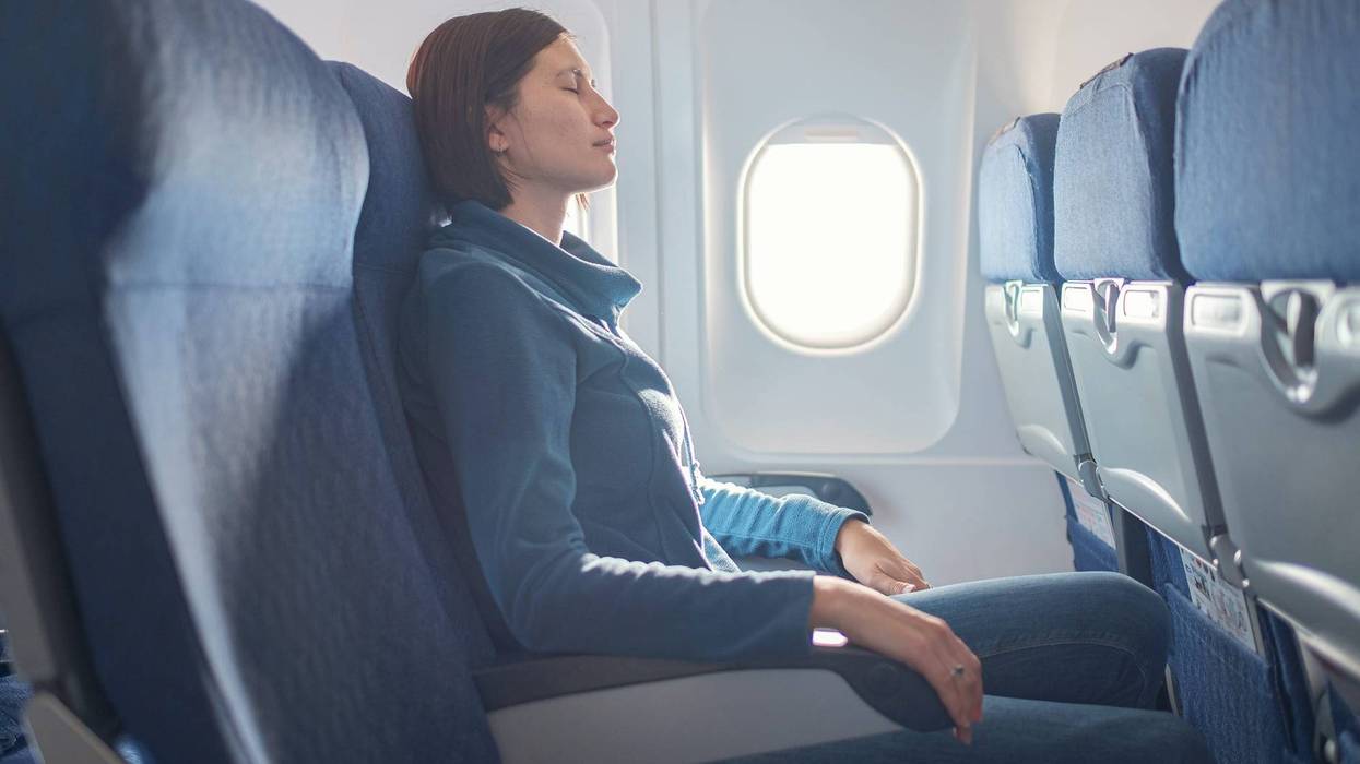 Woman sitting at window of plane during the flight.