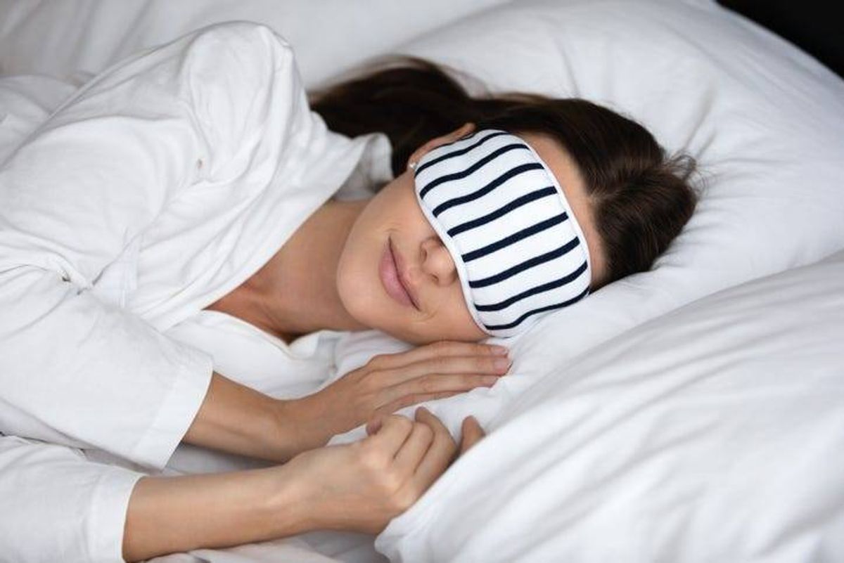 woman sleeps peacefully wearing sleep mask
