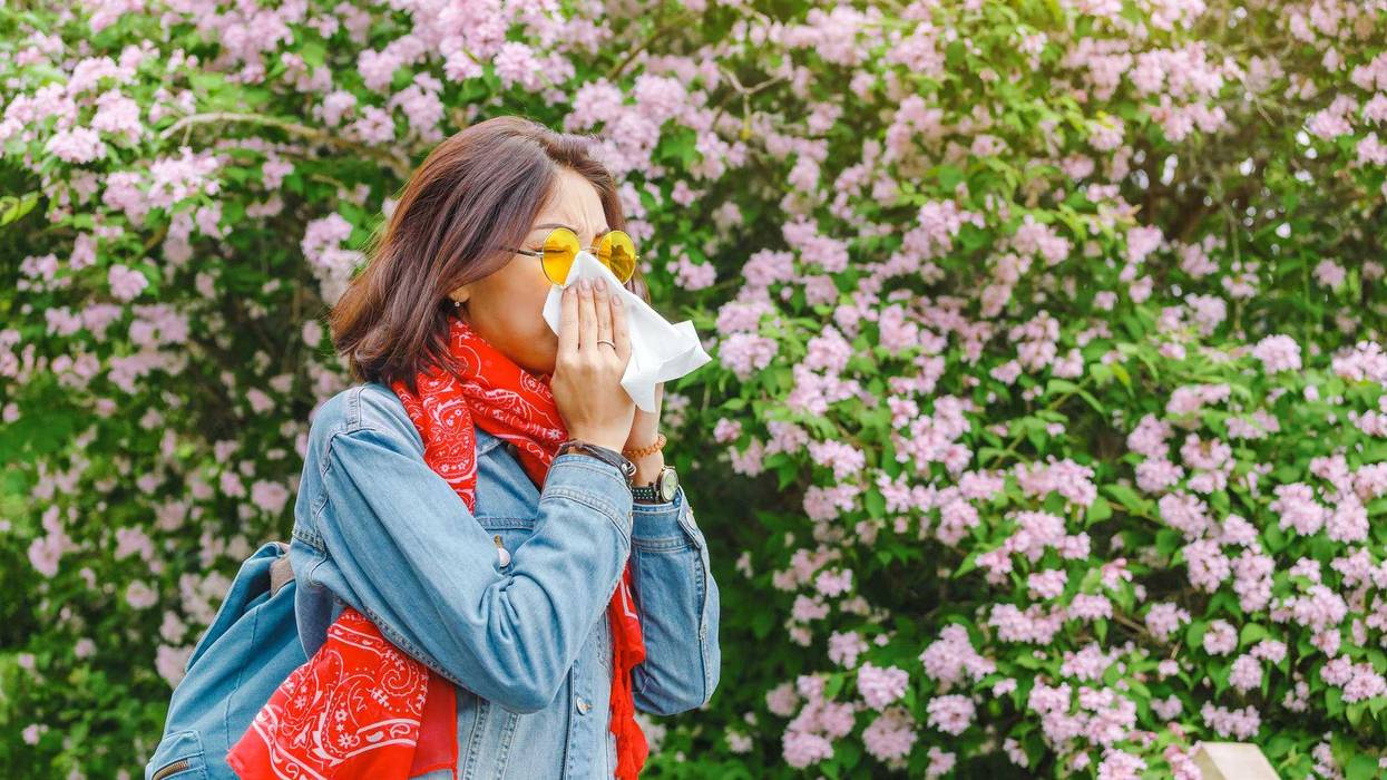 Woman sneezing from nearby pollen.