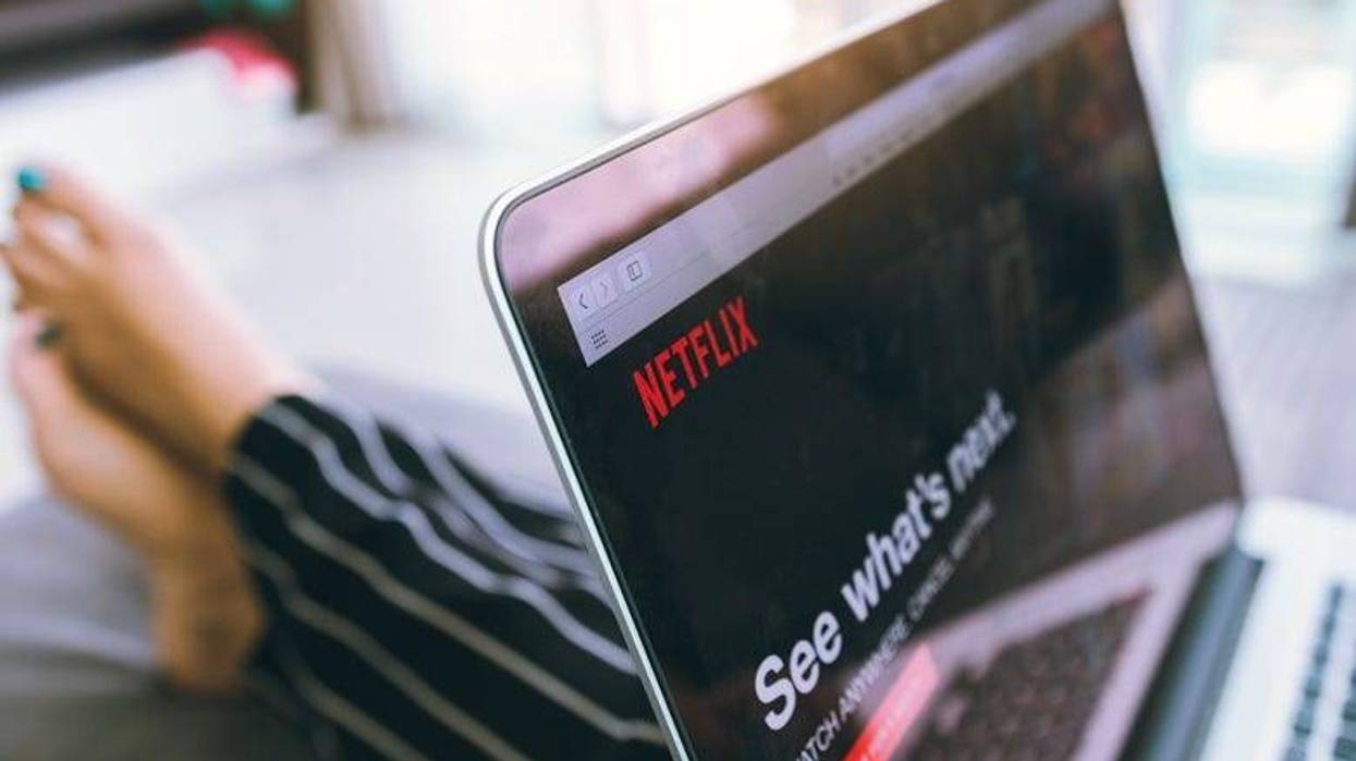 Woman streaming TV on laptop