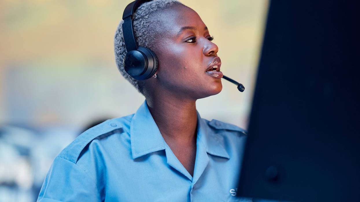 Woman taking emergency phone call at desk