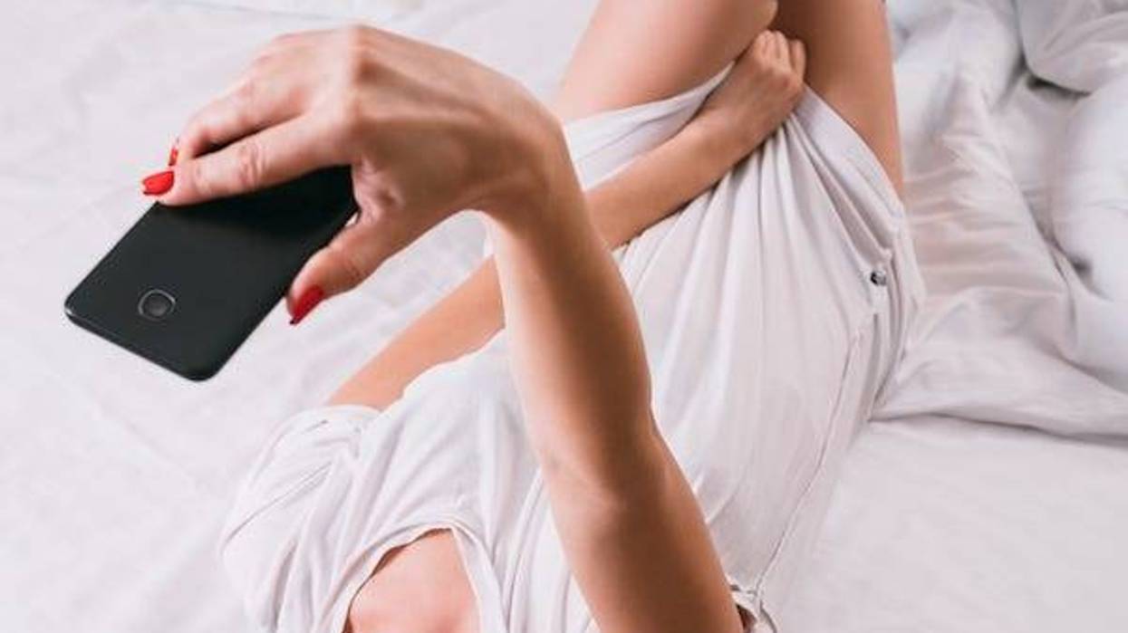 Woman taking sexy selfies in bed