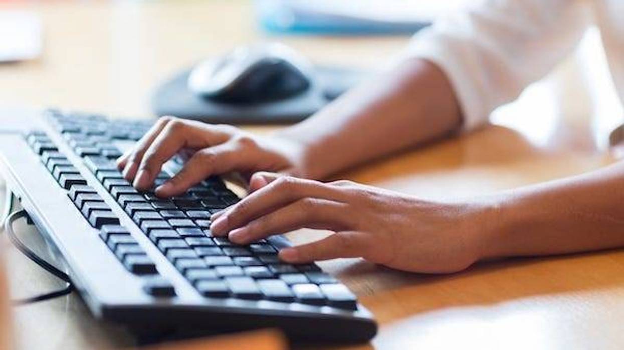 Woman typing on a keyboard