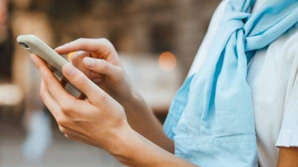 Woman typing on a smartphone