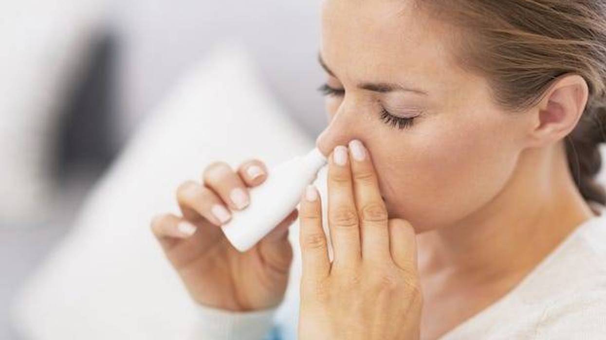 Woman using nasal drops