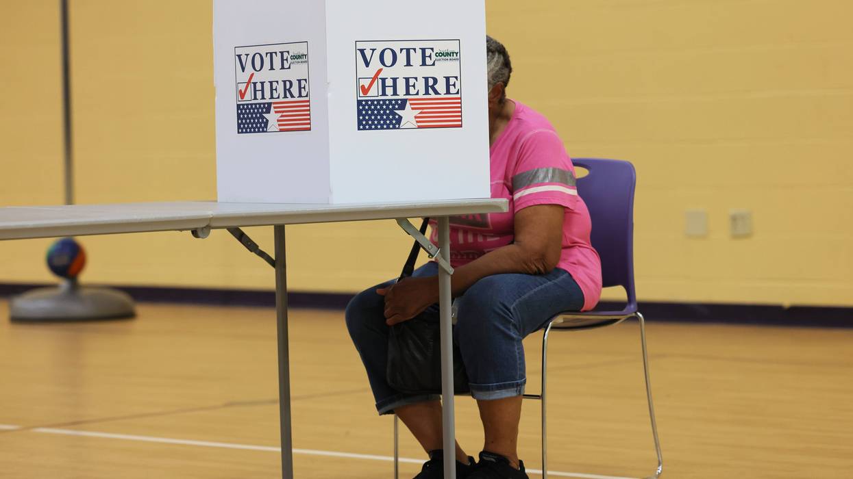 woman votes at st louis county voting booth