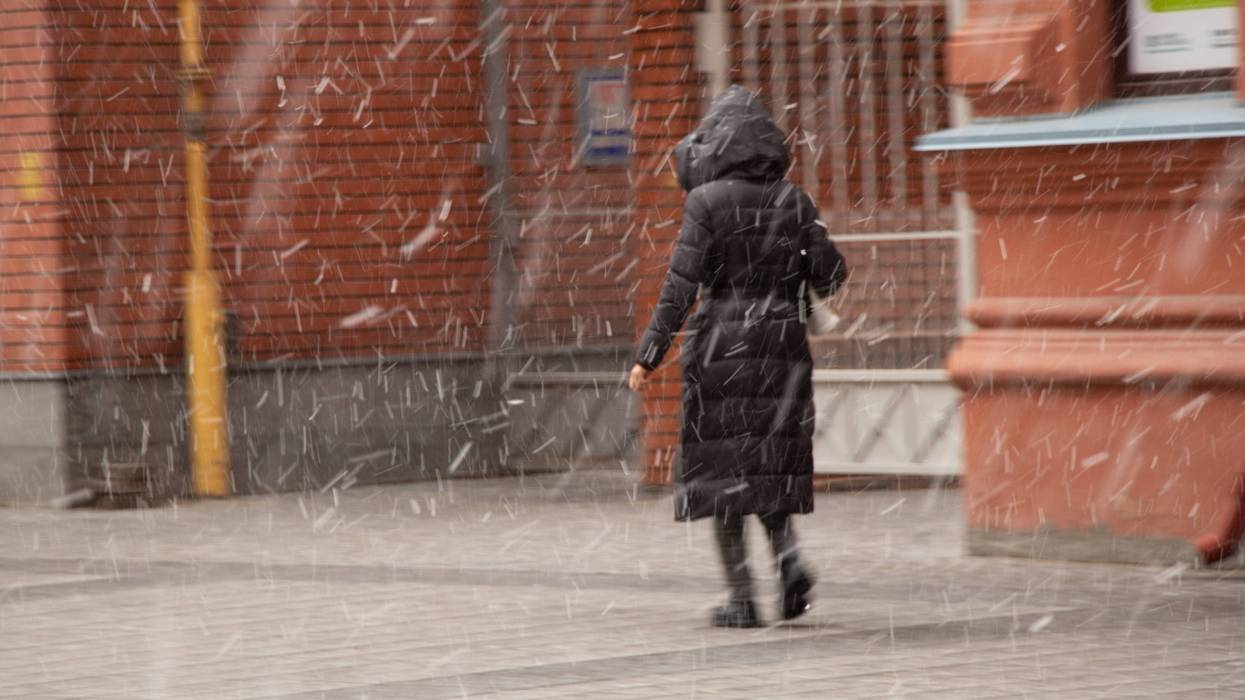 Woman walking in snow squall