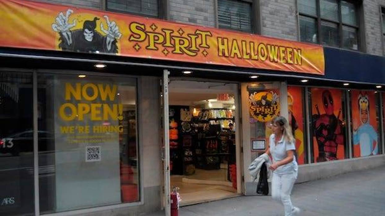Woman walking past a Spirit Halloween