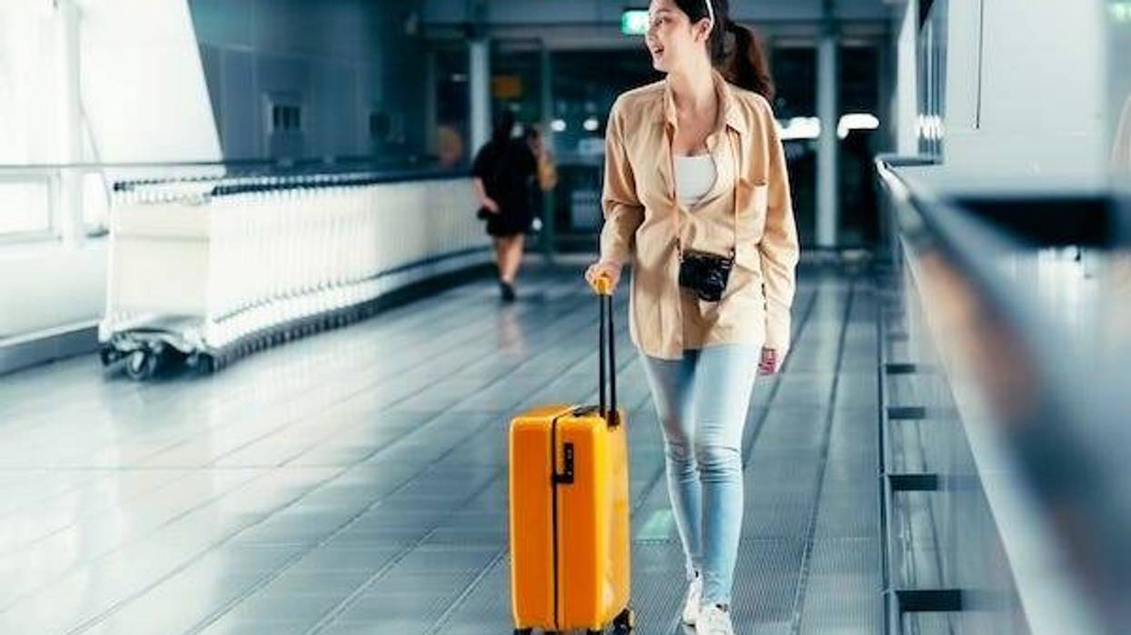 Woman walking through an airport terminal