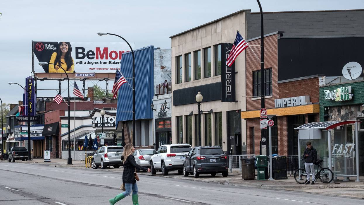 Woman walks across Woodward Avenue in Ferndale