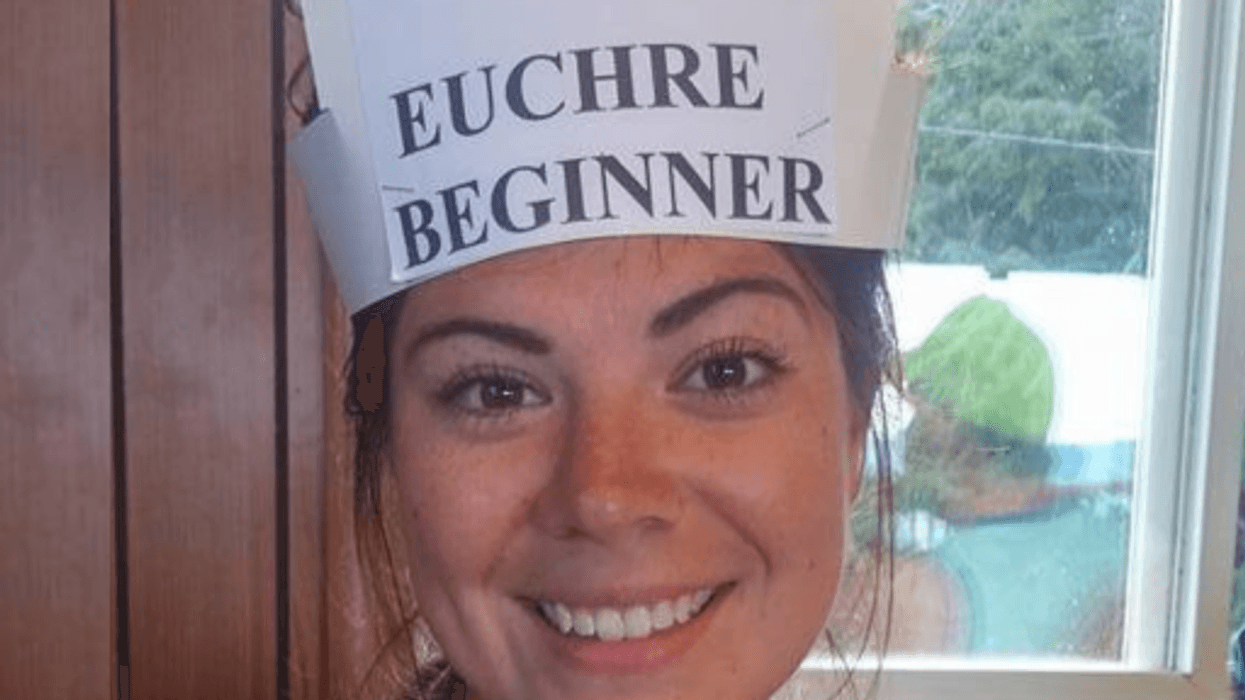 Woman wearing hat that says "Euchre beginner"
