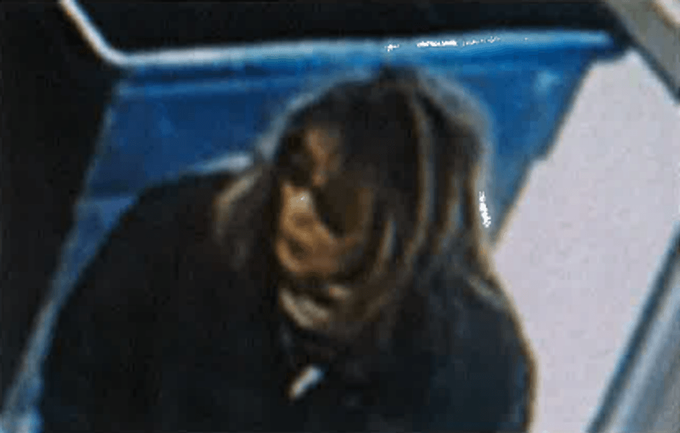 Woman with brown hair and dark glasses