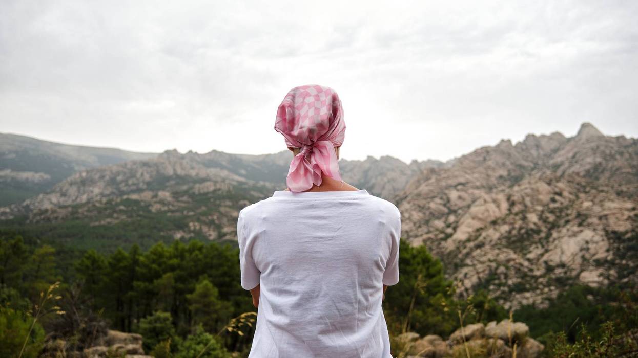 Woman with cancer sitting in a natural space.