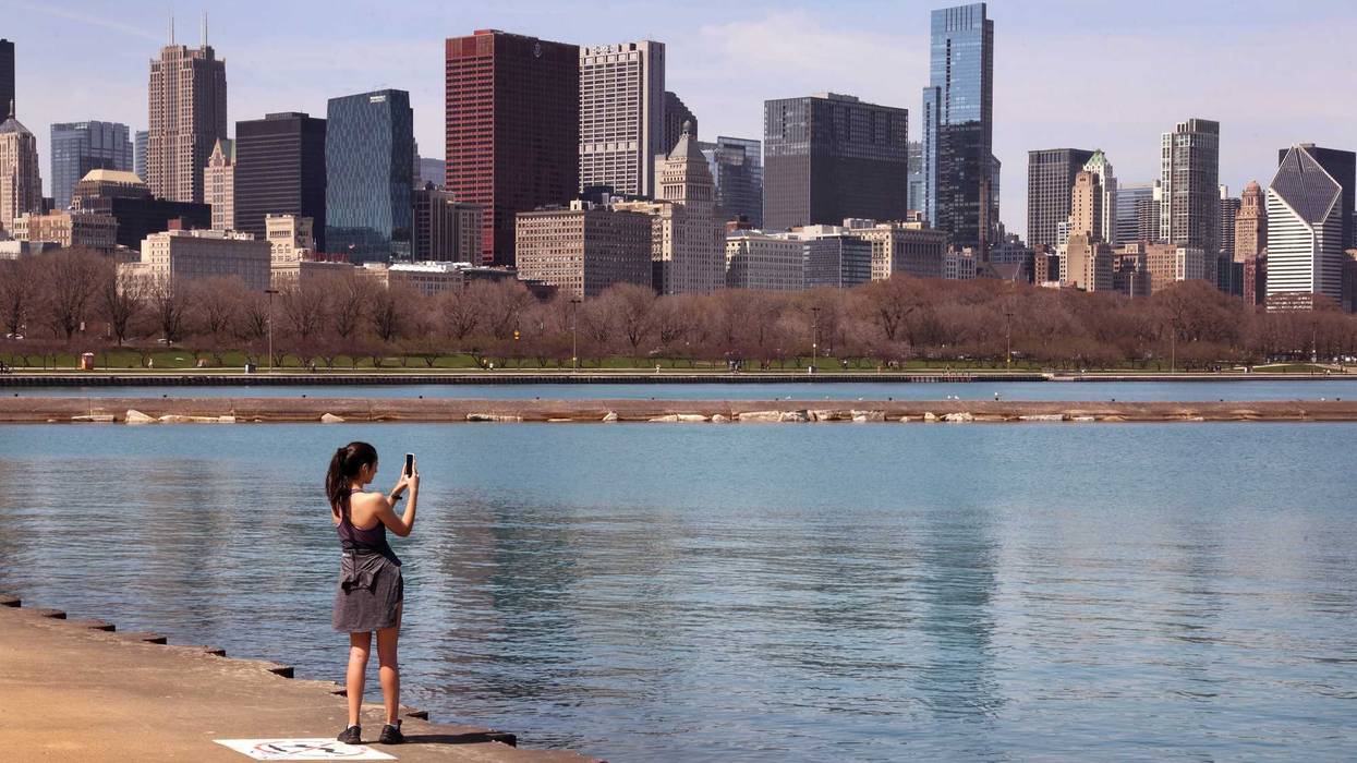 Woman with phone on Chicago's lakefront on sunny day