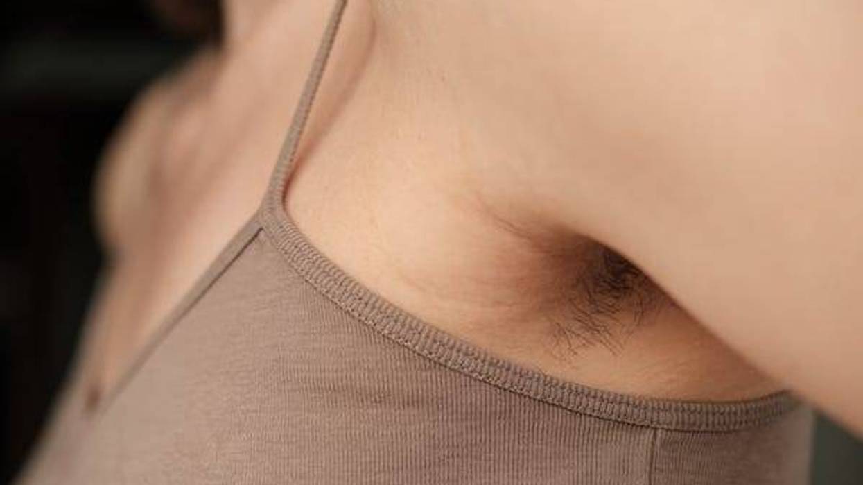 Woman with unshaven arm pits