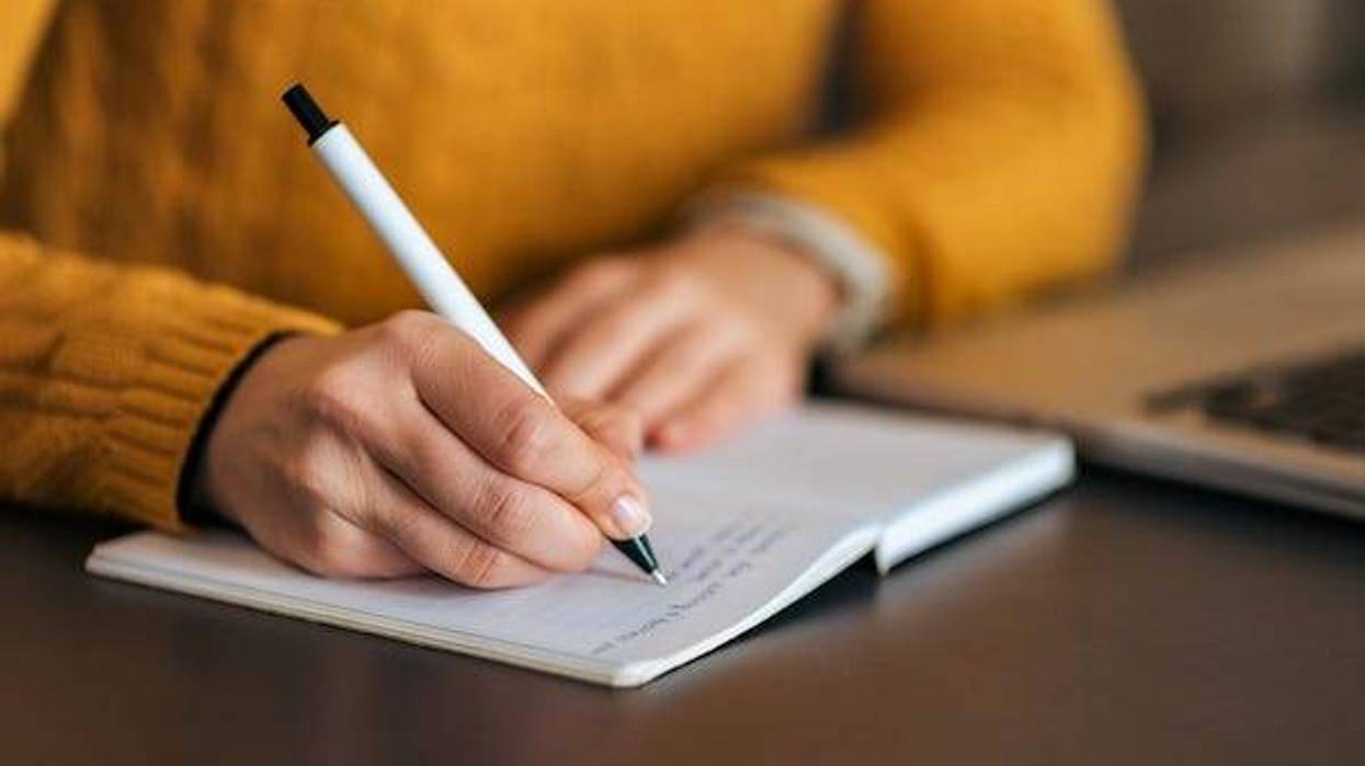 Woman writing in notebook