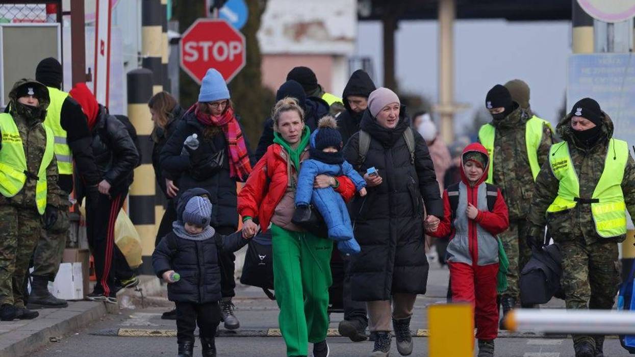 Women and children fleeing war-torn Ukraine walk into Poland at the Korczowa border crossing on March 10, 2022 at Korczowa, Poland. Over one million people have arrived in Poland from Ukraine since the Russian invasion of February 24, and while many are now living with relatives who live and work in Poland, others are journeying onward to other countries in Europe.