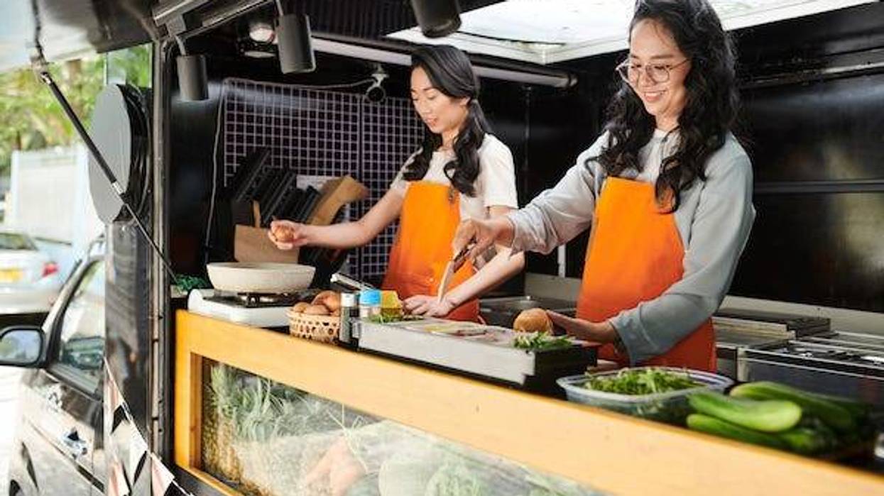 Women making sandwiches for customers in food truck