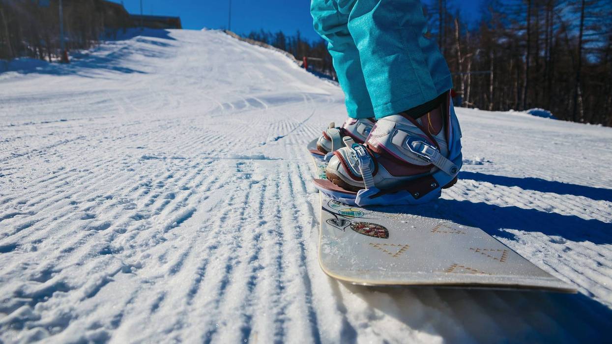 women's boots and snowboard snowboarder in the snow on the mountain