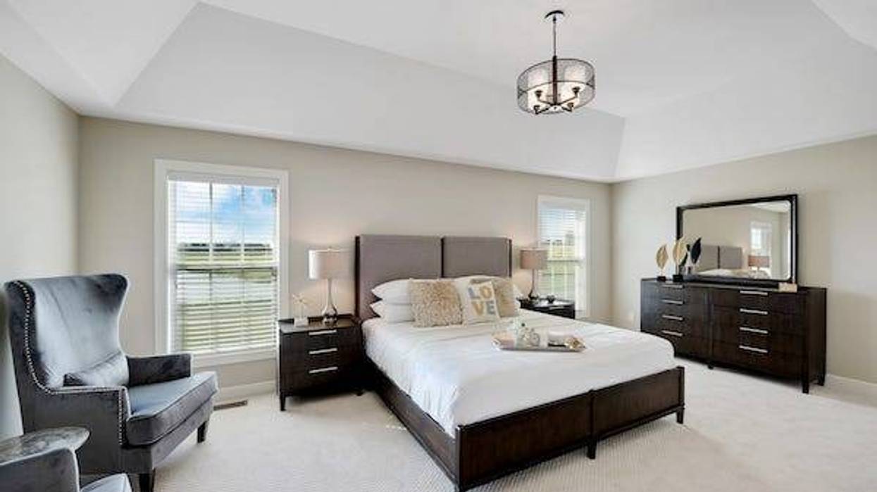 Wonderfully decorated master bedroom with tray ceiling