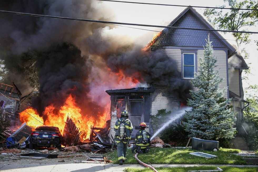 Woodstock firefighters battle a fire after a house exploded Monday afternoon.