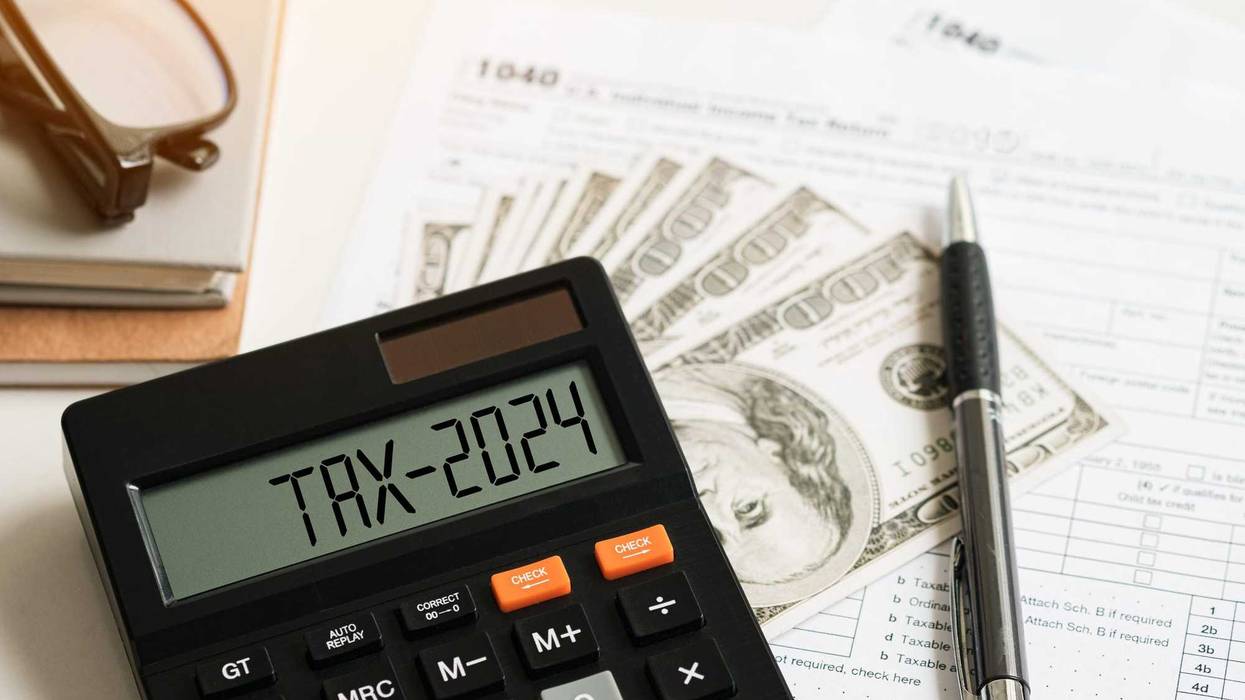 Word Tax 2024 on the calculator on documents.Income Statement. paying the tax rate. Taxation, taxes burden.Business and tax concept.