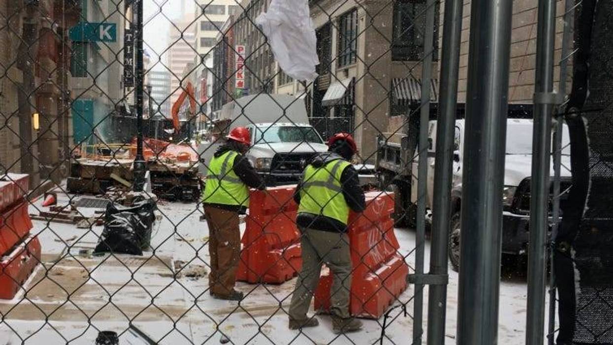 Work crews continue to repair damage done by a water main break in July on Sansom Street near Juniper.