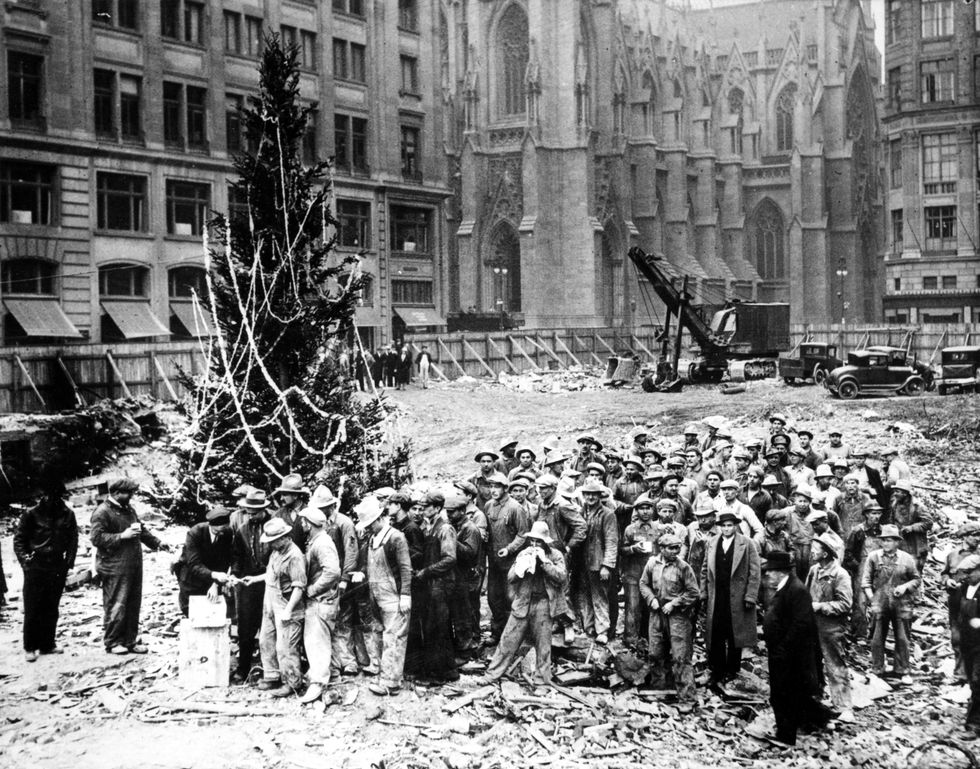Workers building Rockefeller Center put up the first tree in 1931
