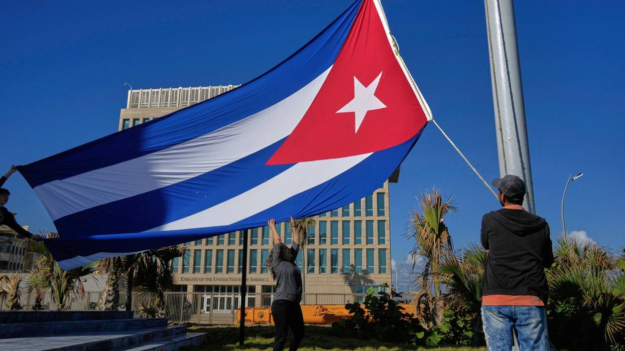 Workers fly the Cuban flag at half-mast at the Anti-Imperialist Tribune near the U.S. embassy in Havana, Cuba, Monday, Jan. 5, 2026, in memory of Cubans who died two days before in Caracas, Venezuela during the capture of Venezuelan President Nicolas Maduro by U.S. forces.
