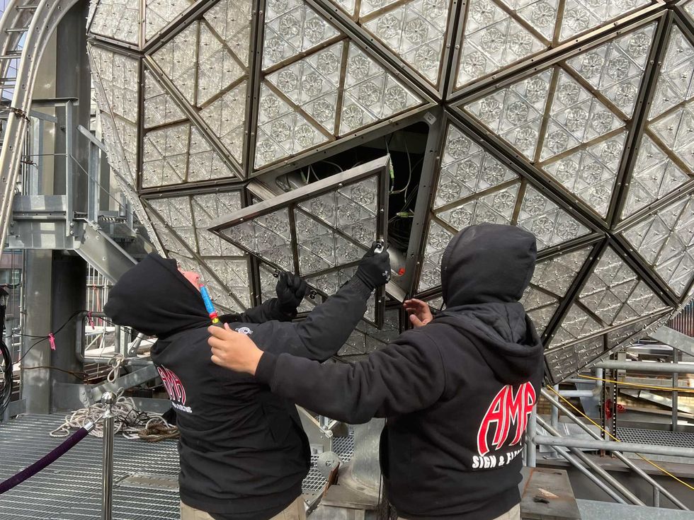 Workers install the ball atop One Times Square on Dec. 27, 2022