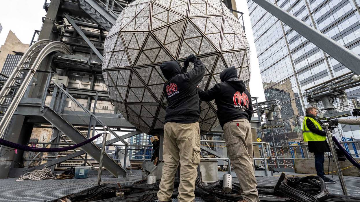 Workers install Waterford Crystal triangles atop One Times Square on Dec. 27, 2022
