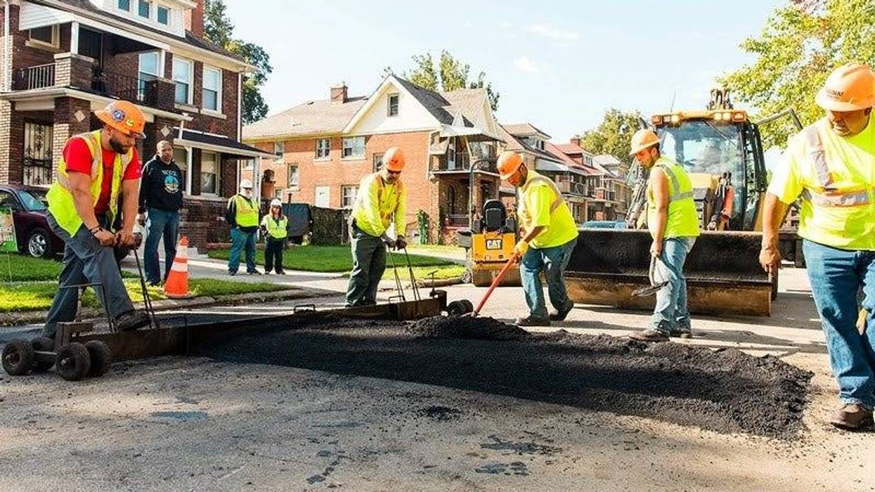 Workers installing speed hump on street