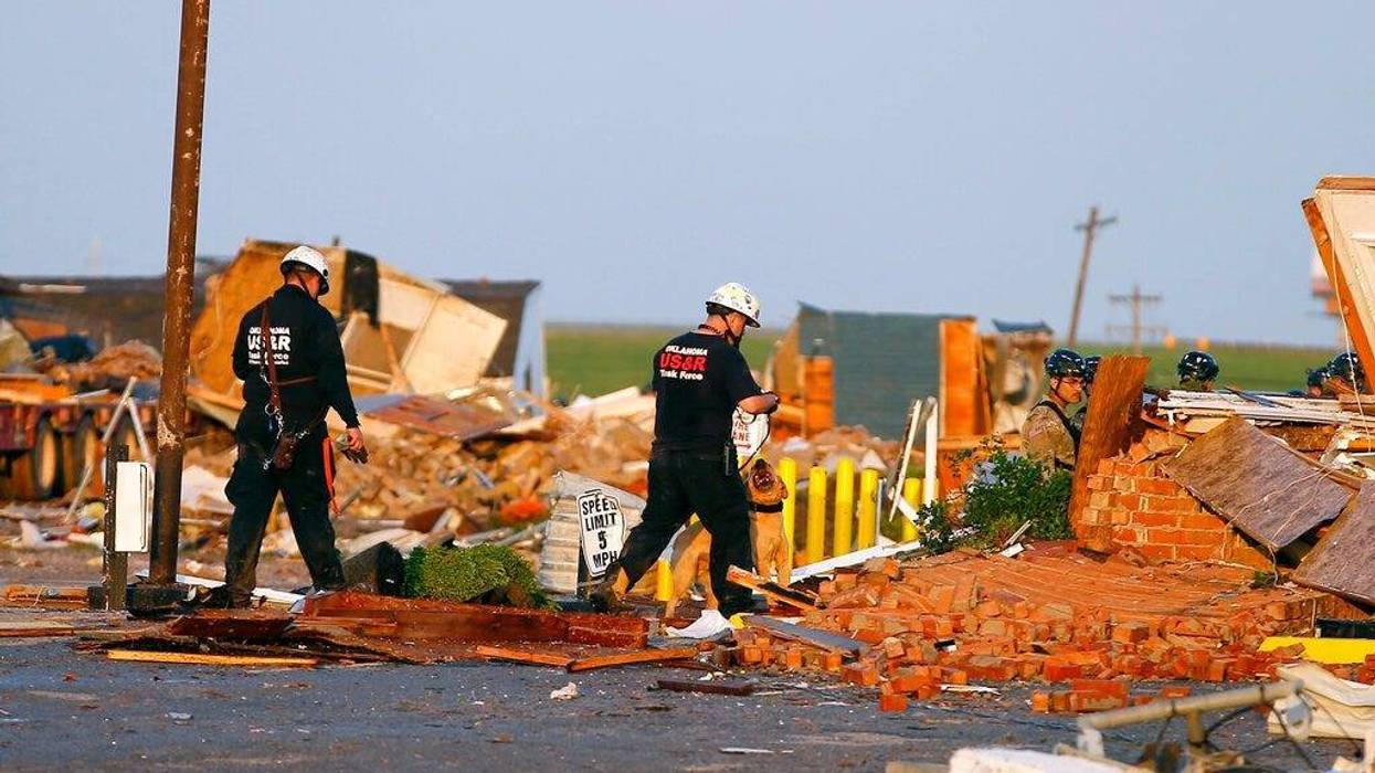 Workers look through tornado damage at the American Budget Value Inn in El Reno, Okla., Sunday, May 26, 2019. The deadly tornado leveled a motel and tore through the mobile home park near Oklahoma City overnight.