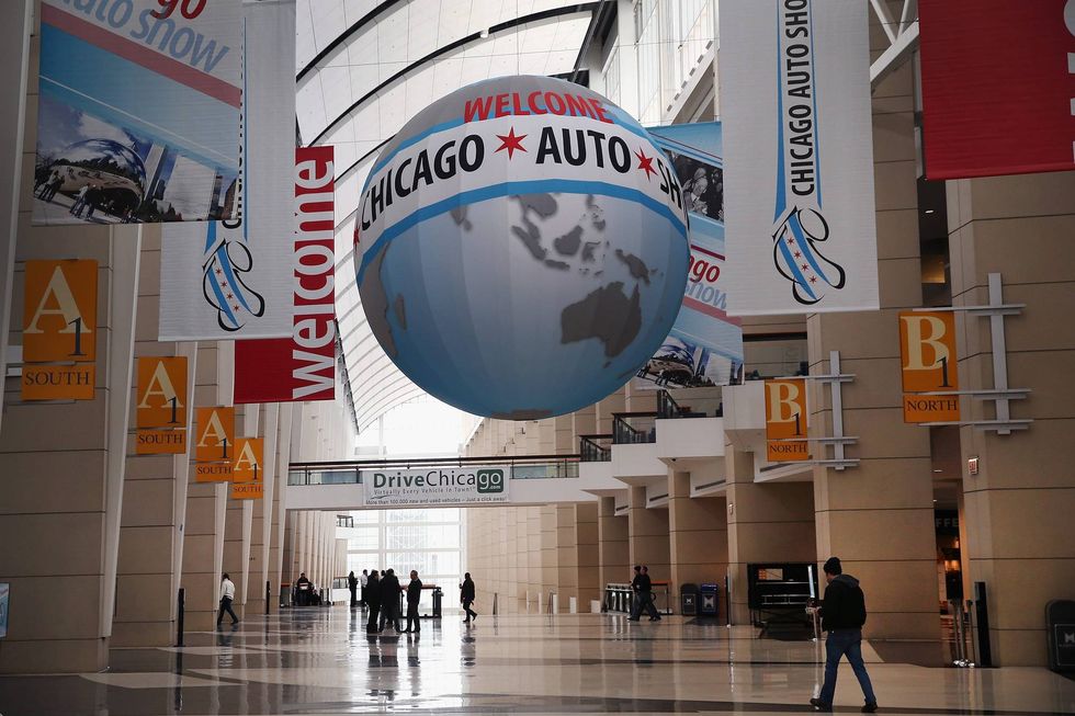 Workers prepare for the open of the Chicago Auto Show on February 5, 2014 in Chicago, Illinois. The show, which is held at McCormick Place, will be open to the public February 8 through February 17.