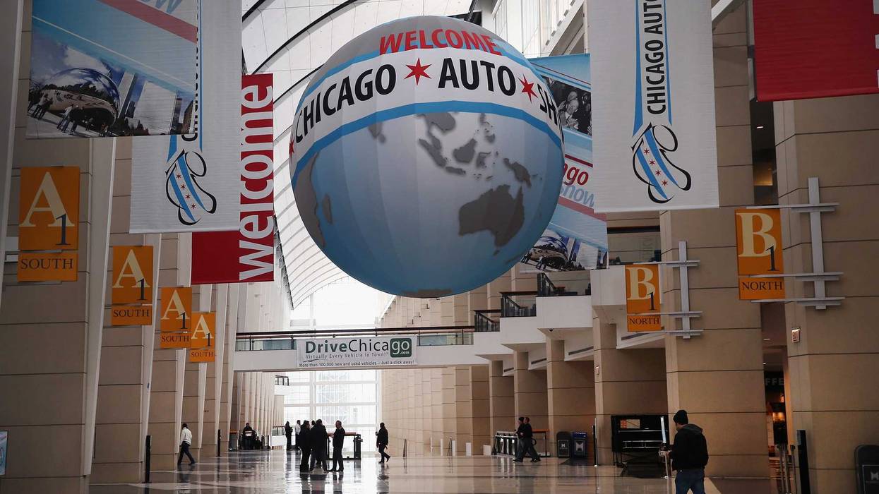 Workers prepare for the open of the Chicago Auto Show on February 5, 2014 in Chicago, Illinois