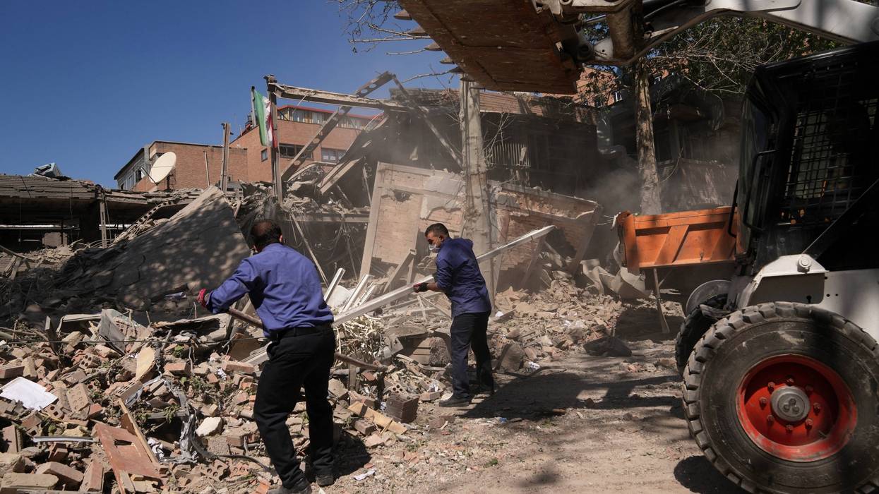 Workers remove debris at Tehran's Sharif University of Technology complex that Iranian authorities say was hit early Monday by a U.S.-Israeli strike, in Tehran, Iran, Monday, April 6, 2026.